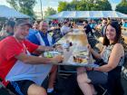 Volunteer and guests enjoying a meal at the St. Nectarios Greek Fest in Palatine