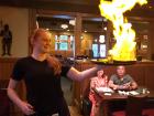 Serving flaming saganaki at Village Squire Restaurant South Elgin Serving flaming saganaki at Village Squire Restaurant South Elgin