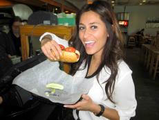 Customer enjoying hot dog at Backyard Grill in Chicago