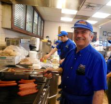 Hard working grill man at Charcoal Delights Restaurant in Chicago