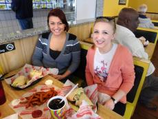 Customers enjoying delicious sandwiches at Burger Baron in Chicago