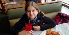Young customer enjoying lunch at Niko's Breakfast Club in Romeoville